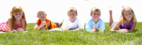 children laying on the grass